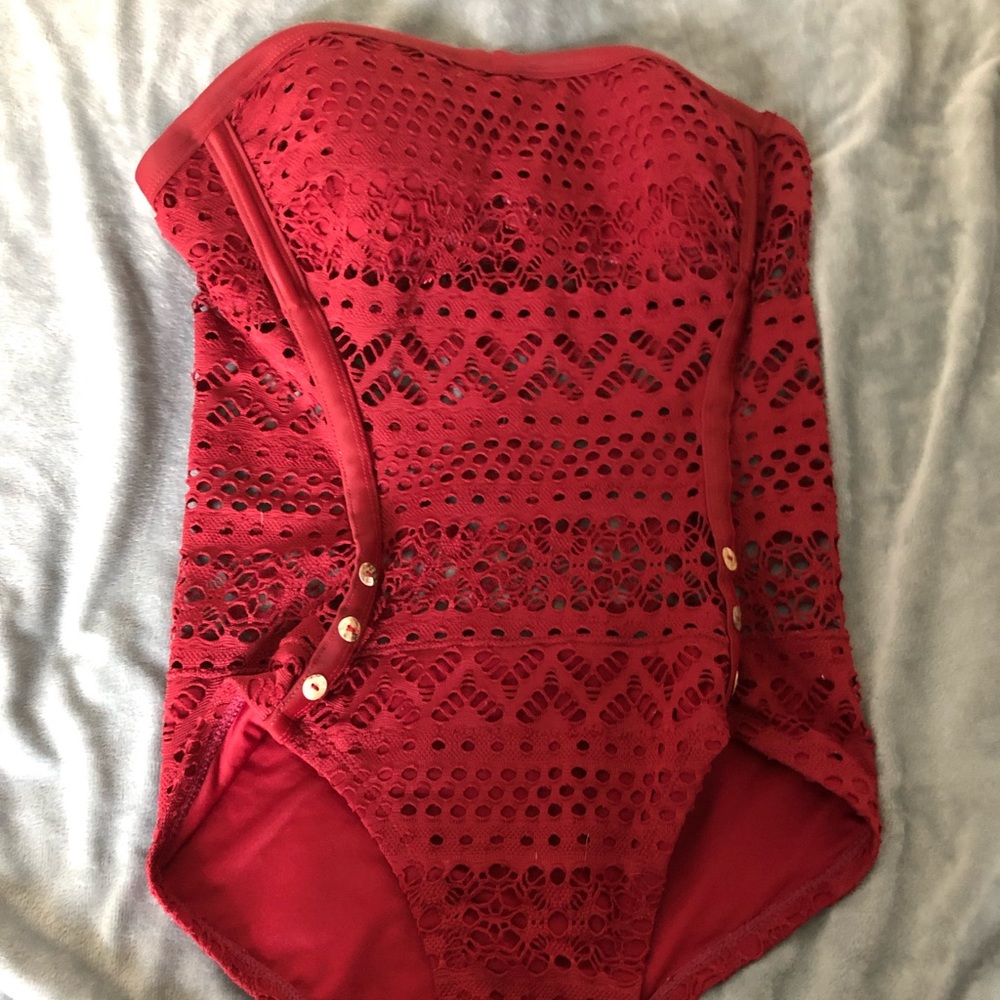 Maroon one piece swimsuit with straps.